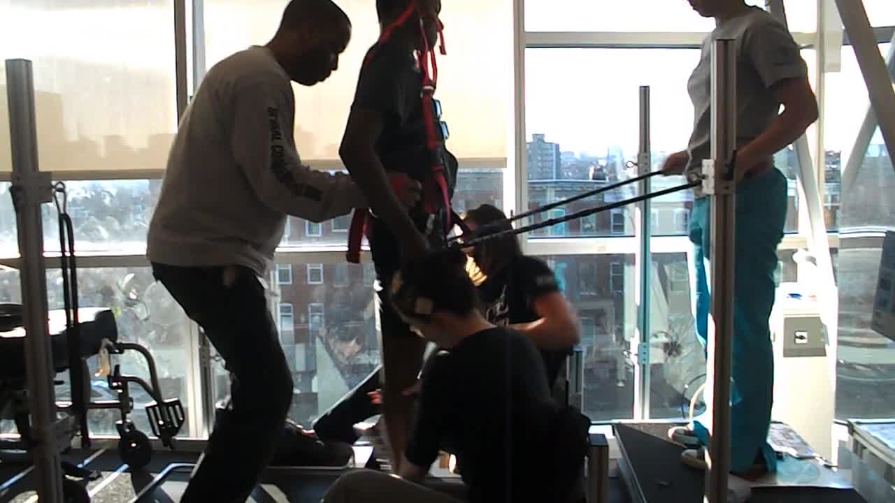 Video of client with electrical stimulation and weight bearing with a team
