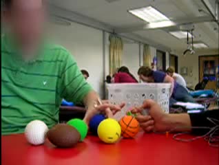 Video of client with electrical stimulation picking up balls