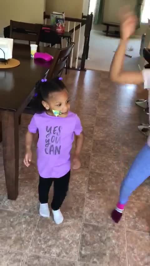 Video of two young sisters mirroring each other's movements