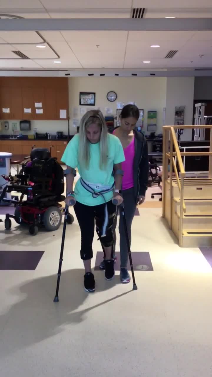 Video of female client walking with devices and electrical stimulation