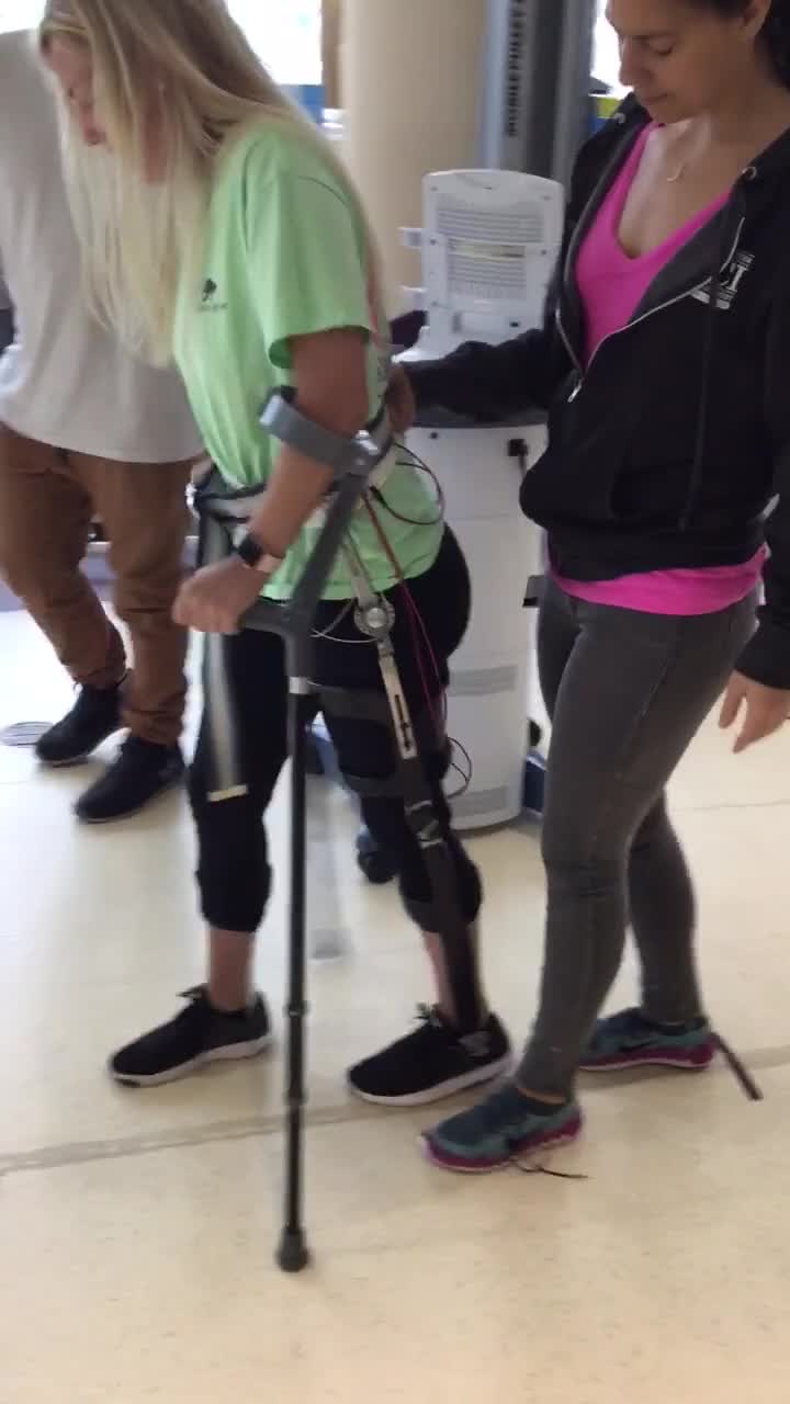Video of female client walking with devices and electrical stimulation, second part of video
